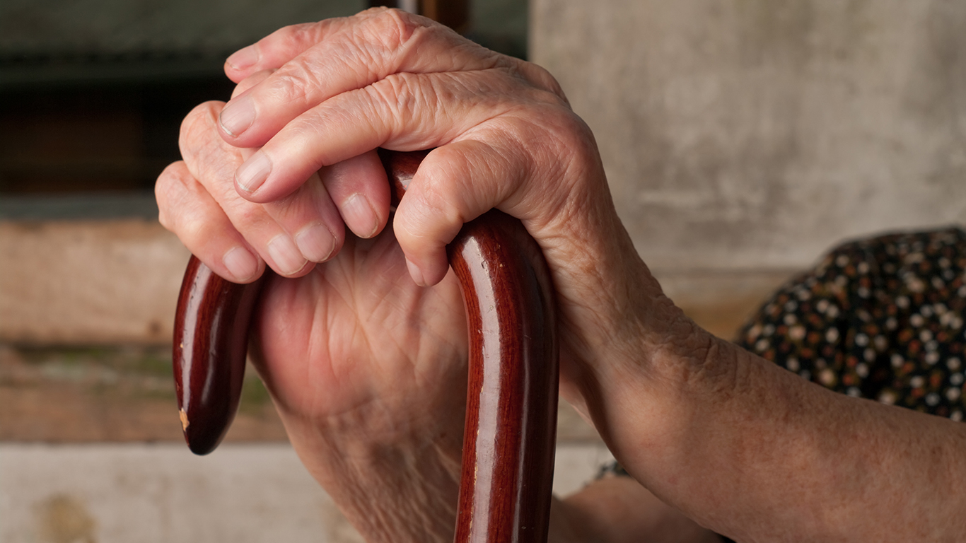 older woman's hands on a cane