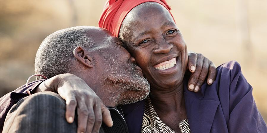 an older man and woman embracing